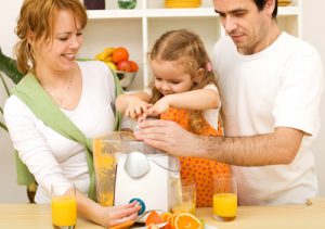 Family making fresh fruit juice together