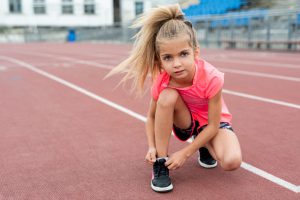 front-view-girl-tying-her-shoelaces-1