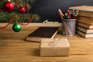 gift-teacher-s-table-with-books-organizer-chalkboard-concept-christmas-new-year_89381-1182