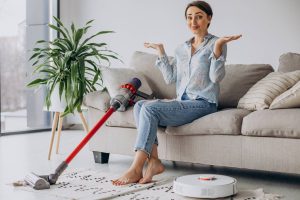 woman-sitting-sofa-choosing-vacuum-cleaner_wp