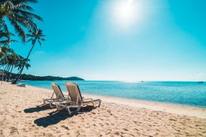 beautiful-tropical-beach-sea-with-chair-blue-sky_wp